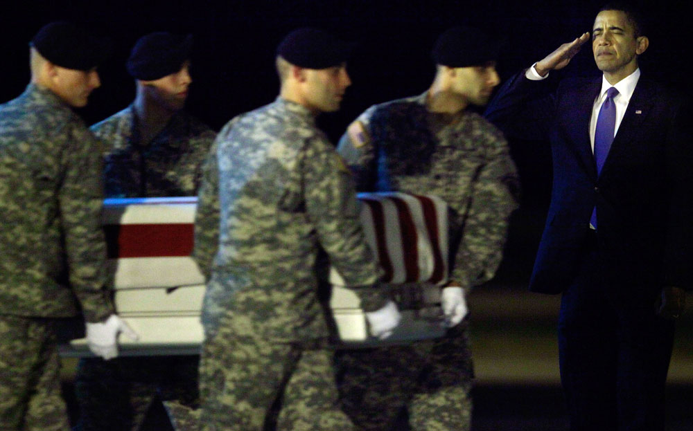President Barack Obama salutes as a U.S. Army carry team moves the transfer case of US Army Sgt. Dale R. Griffin, during a transfer at Dover Air Force Base on October 29, 2009, in Dover, Delaware. Sgt. Griffin who was from Terri Haute, Ind., was killed while supporting Operation Enduring Freedom. (Photo by Mark Wilson/Getty Images) 