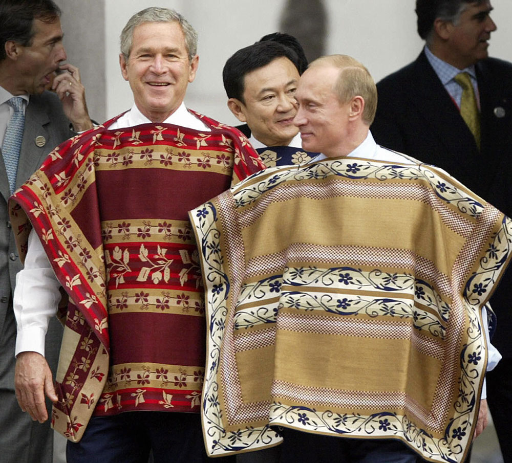 SANTIAGO, CHILE: President George W. Bush (C) wearing a traditional Chilean poncho walks with Russian President Vladimir Putin (right) to the official photo session at the La Moneda Presidential Palace during the APEC Summit 21 November, 2004 Santiago, Chile. (Tim Sloan; AFP/Getty Images) 