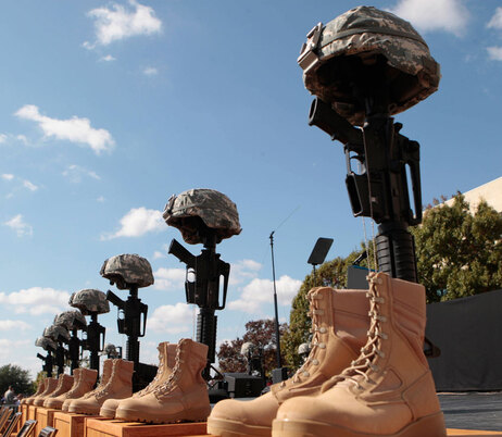 A Soldiers Cross, honoring those who lost their lives in last week's shooting, is seen near the podium where President Barack Obama will speak at the memorial service, Tuesday, Nov. 10, 2009, at Fort Hood, Texas. (AP Photo/Pablo Martinez Monsivais)
