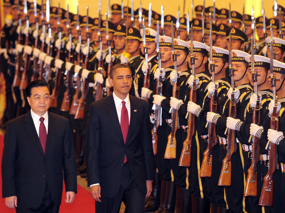 President Barack Obama walks beside Chinese President Hu Jintao during a review of the honor guard welcoming ceremony at the Great Hall of the People in Beijing on November 17, 2009. (Frederic J. Brown/AFP/Getty Images)