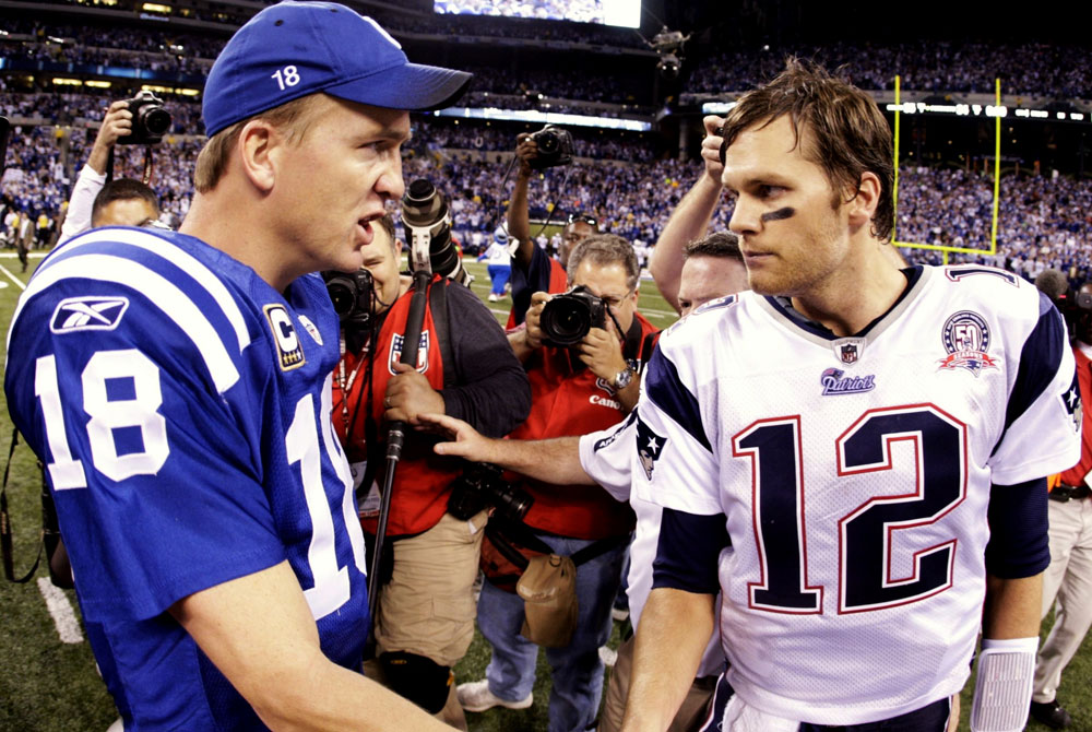 Peyton Manning greets Tom Brady.