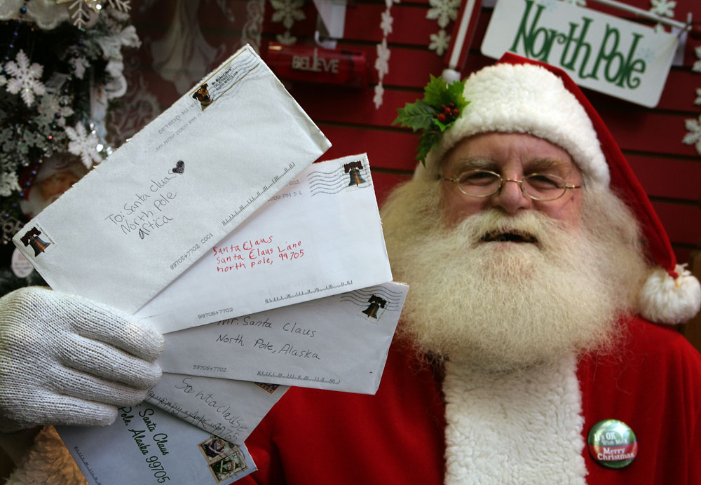  Santa Claus, also known as Patrick Farmer, at Santa Claus House in North Pole, Alaska Wednesday Nov. 18, 2009, holds letters from children sent this year. (AP Photo/Sam Harrel)