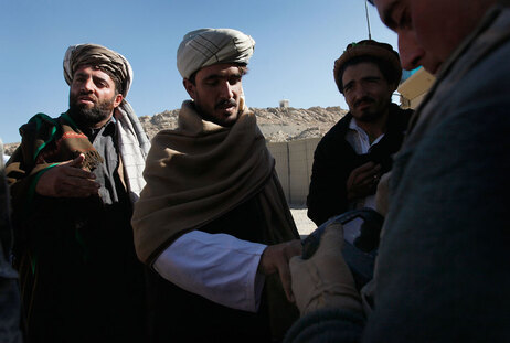 US soldier fingerprints Afghans.