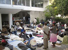 People gather outside a damaged Doctors Without Borders office in Port-au-Prince to receive help after a 7-magnitude earthquake hit the capital city on January 12.