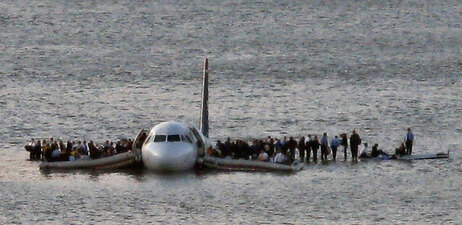 In this file photo from Jan. 15, 2009, airline passengers wait to be rescued on the wings of a US Airways Airbus 320 jetliner that safely ditched in the frigid waters of the Hudson River in New York, after a flock of birds knocked out both its engines. (AP Photo/Steven Day, File)