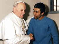 Pope John Paul II converses with his would-be assassin, Turkish terrorist Mehmet Ali Agca, in Agca's prison cell in Rome in this December 27, 1983 photo. (AP Photo/Arturo Mari)