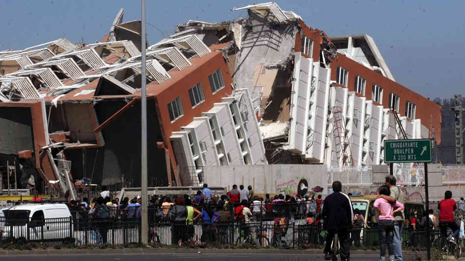 Residents look at a collapsed building in Concepcion, Chile, Saturday Feb. 27, 2010, (AP Photo) Residents look at a collapsed building in Concepcion, Chile, Saturday Feb. 27, 2010, (AP Photo)