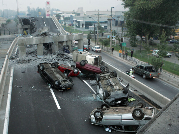 Vehicles that were driving along a highway that collapsed during the earthquake near Santiago are se