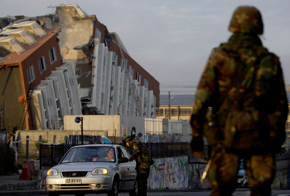 Soldiers patrol in Concepcion , Chile, Wednesday, March 3, 2010. An 8.8-magnitude earthquake struck central Chile early Saturday. The government sent soldiers and ordered a 6 p.m. to -noon curfew to quell looting. (AP Photo/ Natacha Pisarenko)