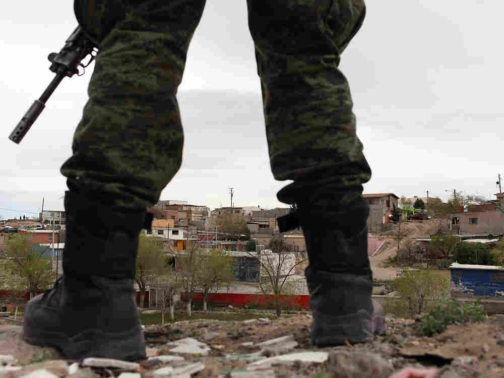 A military police officer stands guard at the scene of a murder on March 23, 2010 in Juarez, Mexico. A military police officer stands guard at the scene of a murder on March 23, 2010 in Juarez, Mexico.