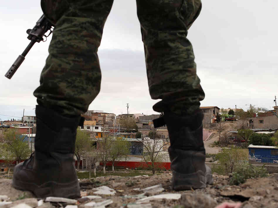 A military police officer stands guard at the scene of a murder on March 23, 2010 in Juarez, Mexico. A military police officer stands guard at the scene of a murder on March 23, 2010 in Juarez, Mexico.
