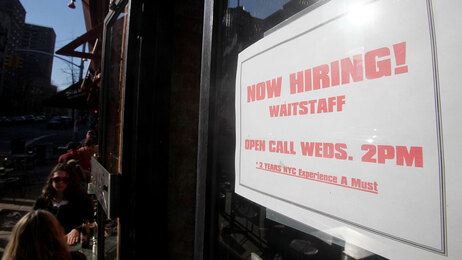 A 'now hiring' sign is seen in the window of a restaurant March 9, 2010 in New York City. (Photo by Mario Tama/Getty Images)