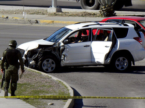 A Mexican soldier patrols the scene inJuarez, Mexico, on March 13, 2010. (Photo by Jesus Alcazar/AFP/Getty Images)