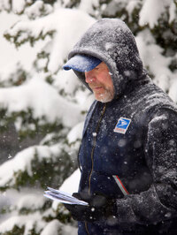 U. S.Post Office letter carrier Tim Bell delivers the mail during a snow storm in Havertown, Pa. Saturday Dec. 19, 2009. (AP Photo/Jacqueline Larma)