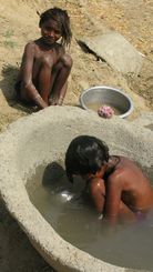 In Puranadih, India, along the Grand Trunk Road, two boys wash up. Instead of soap, they use earth for scrubbing. Philip Reeves/NPR