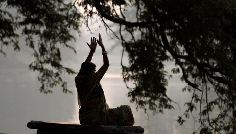A woman performs exercises early morning at a park in Calcutta, India, Friday, March 19, 2010. (AP Photo/Bikas Das)