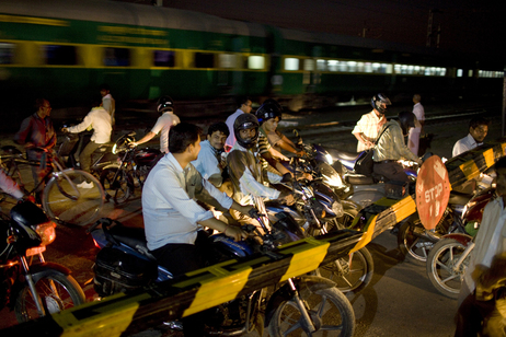 Just outside Noida at a busy railroad crossing, impatient motorists and bicyclists stand inches away from oncoming traffic wanting to continue their journey. (Kainaz Amaria for NPR)