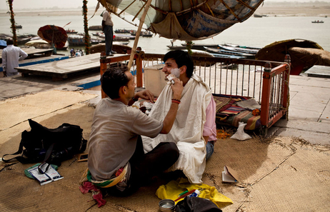 Barber Mahendra Singh shaves NPR's Nishant Dahiya on the banks of the Ganges River in Varanasi, India. April 2010. (Kainaz Amaria for NPR)