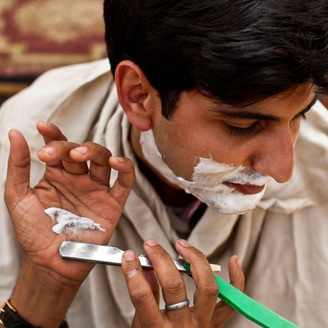 Barber Mahendra Singh shaves NPR's Nishant Dahiya on the banks of the Ganges River in Varanasi, India. April 2010. (Kainaz Amaria for NPR)