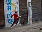 A young boy runs past a leather factory in Kanpur, India. (Photo by Kainaz Amaria for NPR) A young boy runs past a leather factory in Kanpur, India. (Photo by Kainaz Amaria for NPR)