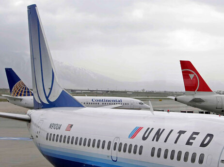 A Continental Airlines jet pulls away from the gate as a United Airlines and Northwest Airlines jets sit at the gate at the Salt lake International Airport April 15, 2008 in Salt Lake City, Utah. (Photo by George Frey/Getty Images)