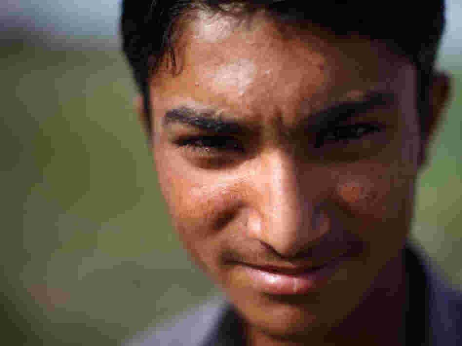 Mohammad Shoib, 16, sells little gifts at a stand near the border with India. (Photo by John Poole/N