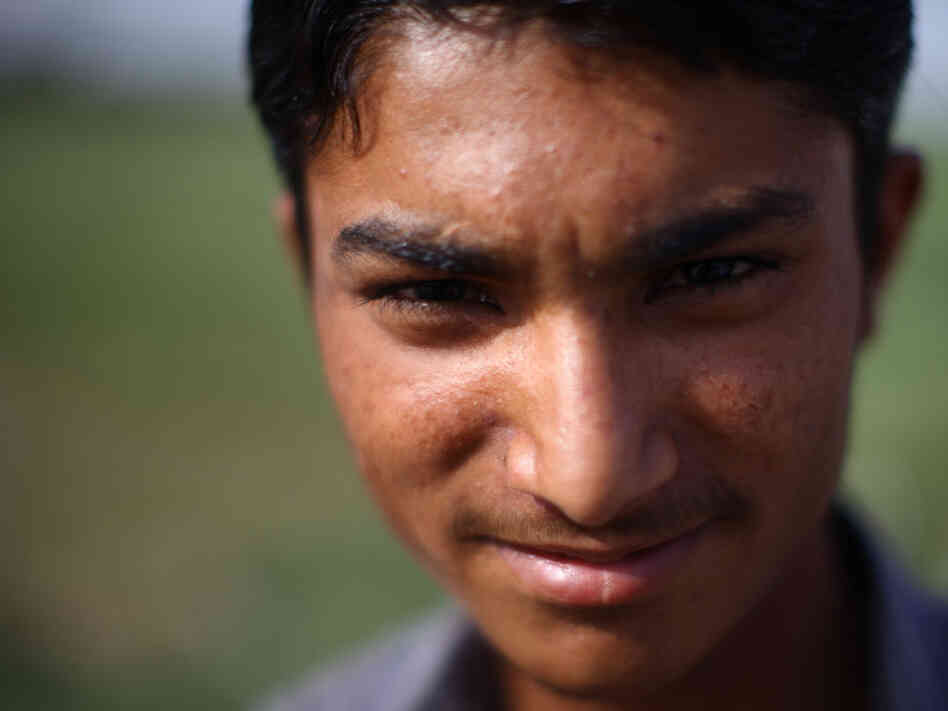 Mohammad Shoib, 16, sells little gifts at a stand near the border with India. (Photo by John Poole/N