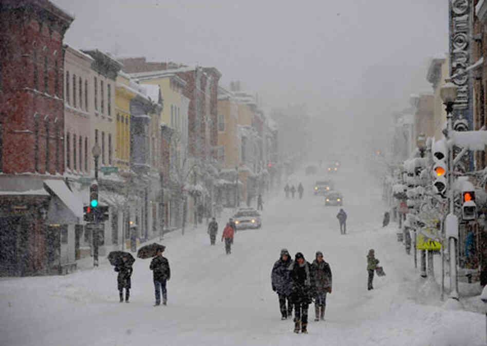 During the recent snow storm, pedestrians walk in the street to avoid sidewalks in the Georgetown ne During the recent snow storm, pedestrians walk in the street to avoid sidewalks in the Georgetown ne