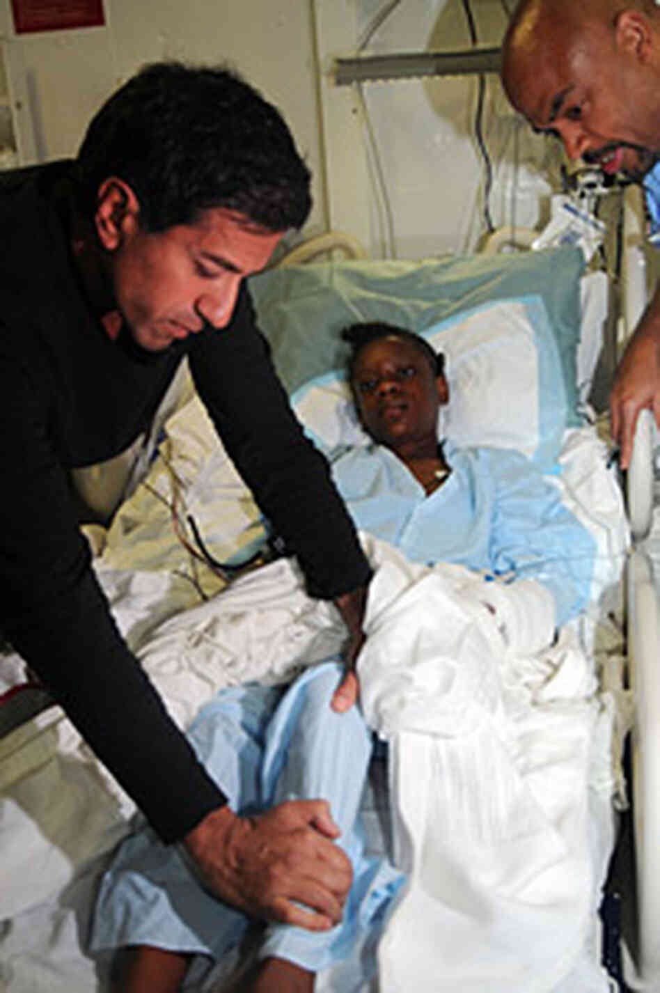 Chief CNN Medical Correspondent Dr. Sanjay Gupta examines an injured Haitian girl in the medical fac Chief CNN Medical Correspondent Dr. Sanjay Gupta examines an injured Haitian girl in the medical fac