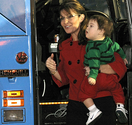 Former Republican vice presidential candidate and Alaska Governor Sarah Palin holds her son as she arrives for a book signing event for her new book, <em>Going Rogue</em>, in Grand Rapids, Michigan.