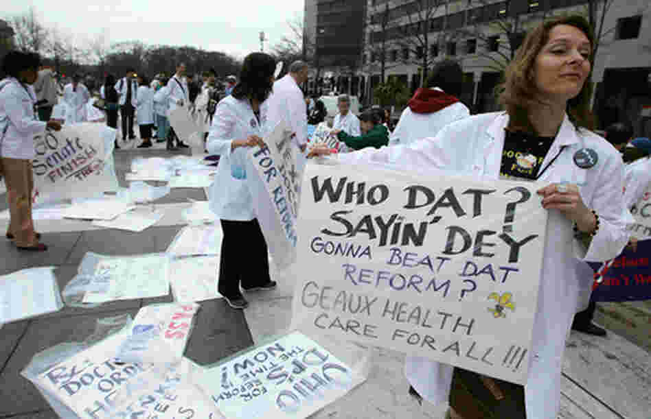 Woman at rally holding Who Dat? placard. Woman at rally holding Who Dat? placard.