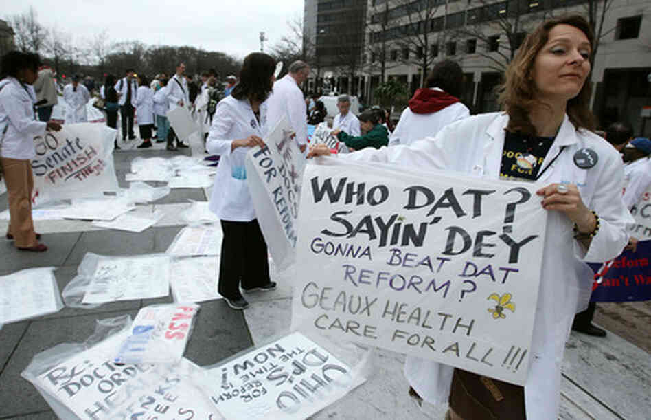 Woman at rally holding Who Dat? placard. Woman at rally holding Who Dat? placard.