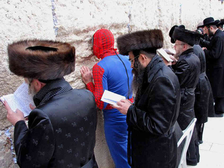 Image of man in Spiderman costume at the Wailing Wall. Image of man in Spiderman costume at the Wailing Wall.