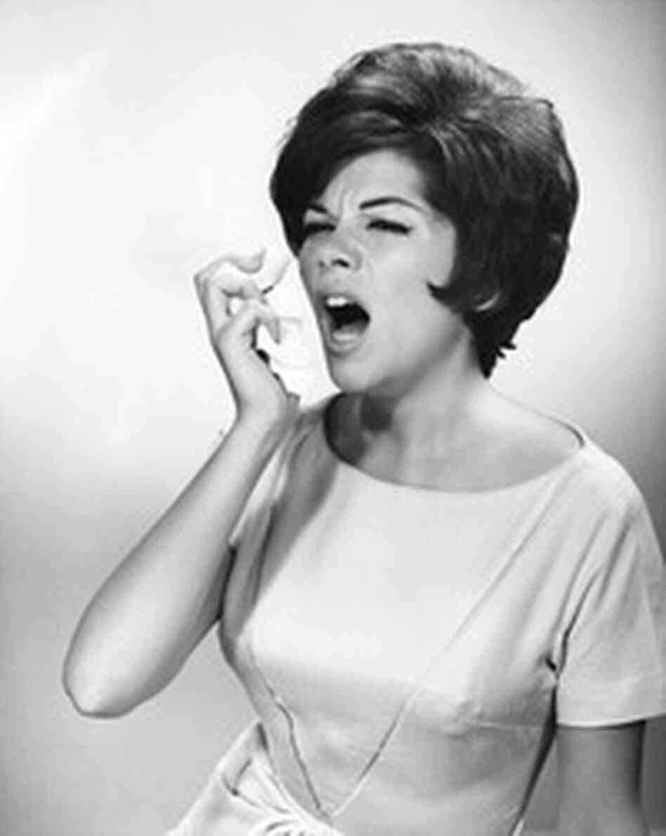 Archival photo of woman sneezing. Archival photo of woman sneezing.