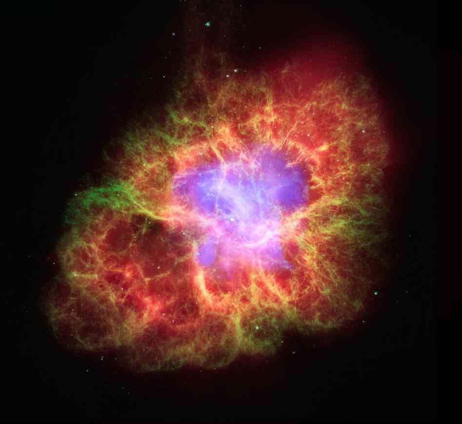 This image was taken by NASA's Spitzer telescope.  A star's spectacular death in the constellation Taurus was observed on Earth as the supernova of 1054 A.D.  Now, almost a thousand years later, a superdense neutron star left behind by the stellar death is spewing out a blizzard of extremely high-energy particles into the expanding debris field known as the Crab Nebula.