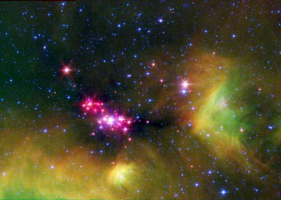 Infant stars glow in this infrared image of the Serpens star-forming region, captured by NASA's Spitzer telescope. The reddish-pink dots are baby stars deeply embedded in the cosmic cloud of gas and dust that collapsed to create it.  The Serpens star-forming region is located approximately 848 light-years away in the Serpens constellation.