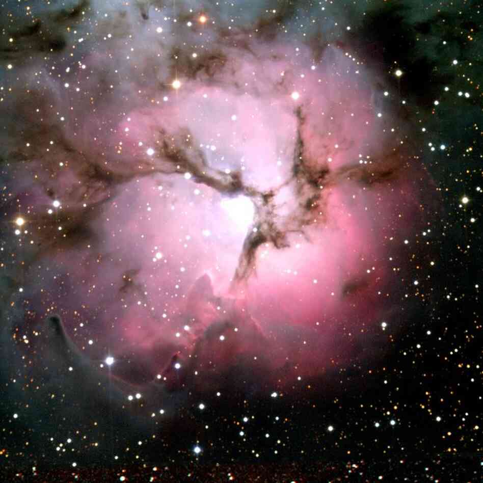 This Hubble image shows the Trifid Nebula, a giant star-forming cloud of gas and dust located 5,400 light-years away in the constellation Sagittarius.