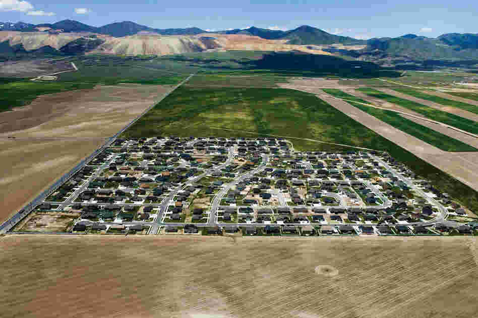 Isolated exurban communities in Utah built on cheap agricultural land depend on cars for nearly every activity. To access urban centers, residents often have to commute long distances. Because the land is virtually undeveloped, all aspects of modern infrastructure (water, sewer, electric and roads) must be extended.
