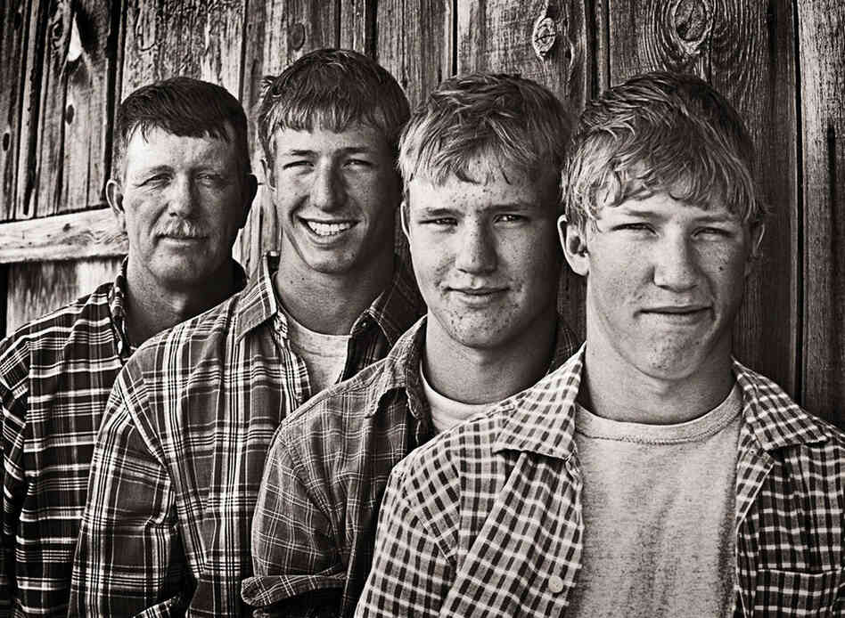 Stan Horton (left) stands with his sons, Garrett, Shay and Brent on their alfalfa farm near Riverton, Wyo.