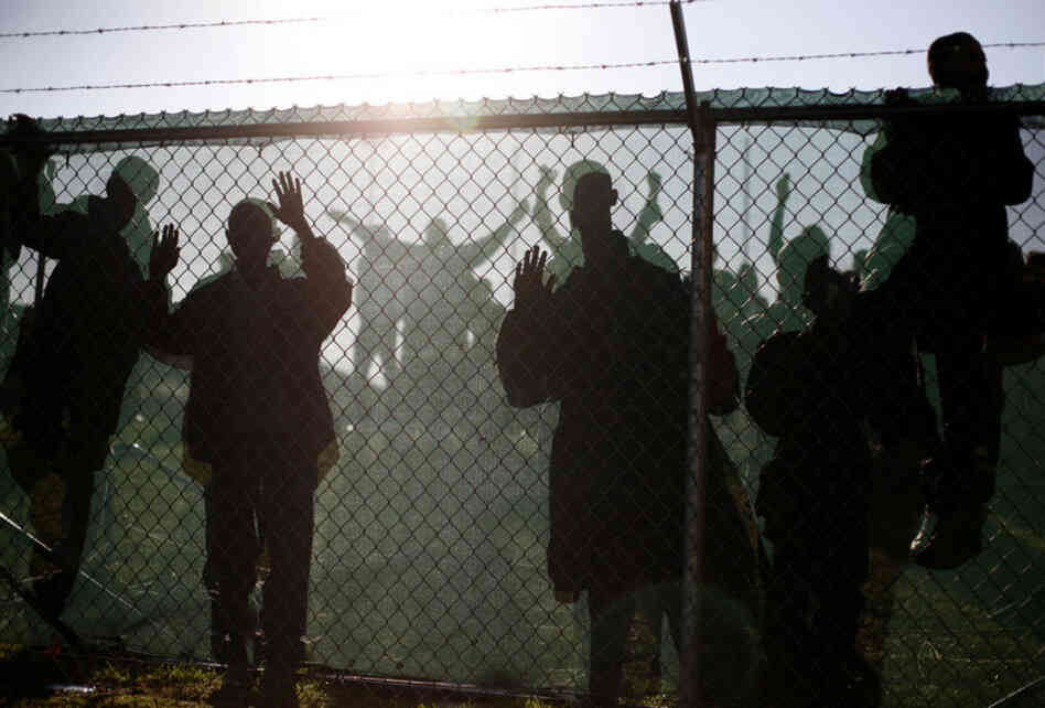 A crowd of children waits behind a fence on the track at Duncanville High School in Duncanville, Texas, as Obama arrives to speak.