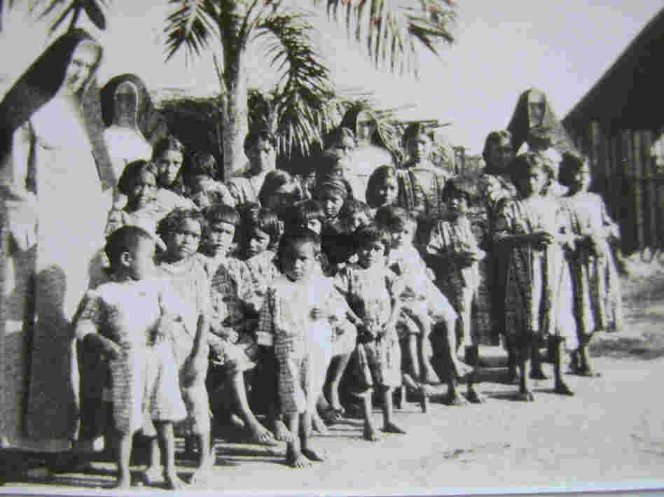 Mundurucu mission children stand with German nuns. 