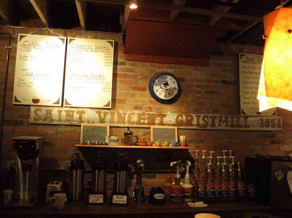 Behind the counter of the Coffehouse, a sign displays the Gristmill's founding year.
