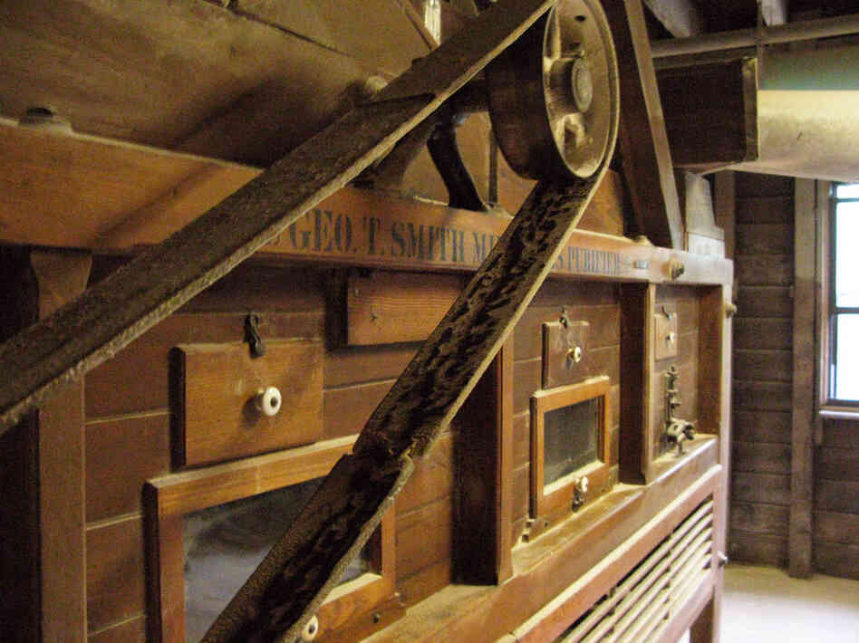 The Gristmill's grain cleaner is located on the second floor, above the burhstones.  Here grain is cleaned before falling one floor below into a hopper, which transfers it to burhstones for grinding.