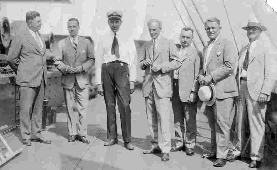 Ford executives stand on the deck of the Lake Ormoc.  Left to right: William Cowling, Edsel Ford, Einar Oxholm, Henry Ford, Pete Martin, Charles Sorensen, and AlbertWibel. 