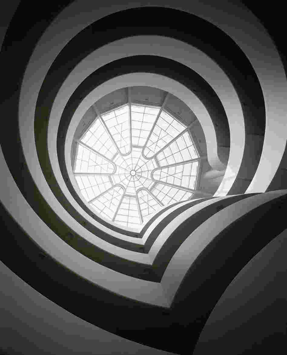 Artworks are displayed on the ramp concourse, which spirals upward to the building's apex. 