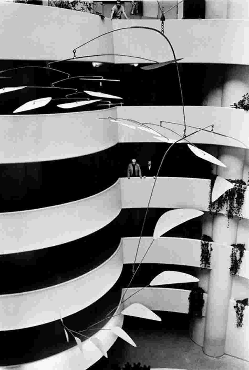 Artist Alexander Calder (left) and Guggenheim Museum Director Thomas Messer study the 35-foot mobile "Ghost" in the main rotunda of the museum on Nov. 3, 1964, in New York.  