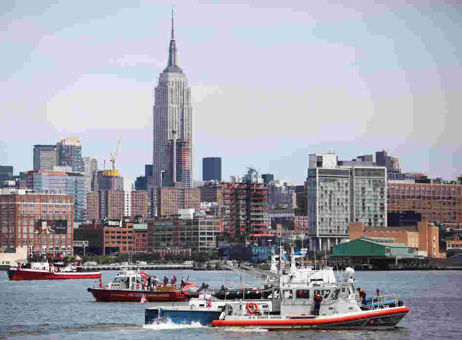 Rescue boats search the Hudson near Hoboken, N.J. A small plane with three people aboard took off from Teterboro Airport in New Jersey before colliding with a helicopter owned by Liberty Tours that carried six people. 