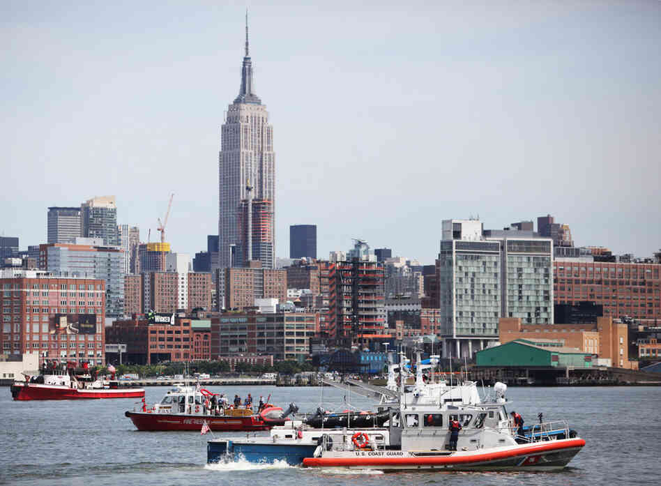 Rescue boats search the Hudson near Hoboken, N.J. A small plane with three people aboard took off from Teterboro Airport in New Jersey before colliding with a helicopter owned by Liberty Tours that carried six people. 