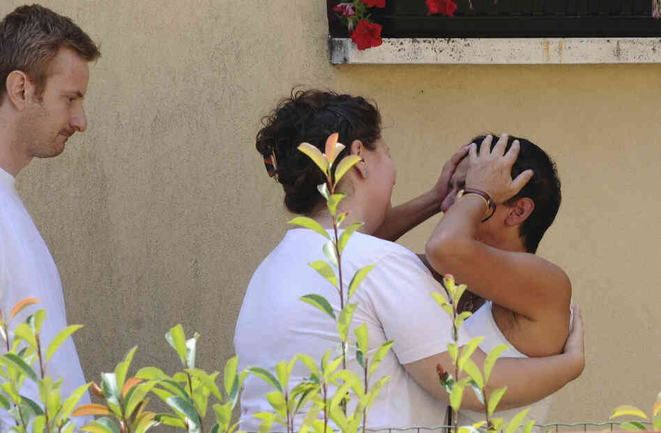 Silvia Rigamonti, right, is comforted by friends and relatives at her house in Trebbo di Reno, near Bologna, Italy, Monday. Rigamonti is the wife of crash victim Michele Norelli. Their 17-year-old son, Filippo, also died. 