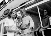 Eunice Kennedy Shriver stands with brother Ted Kennedy and one of Shriver's grandchildren on a boat in Hyannis Port, Mass., on Aug. 5, 1990.